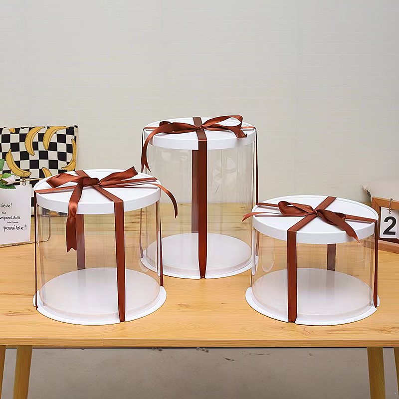 Circular transparent cake boxes wrapped in ribbon Marah Design