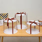 Circular transparent cake boxes wrapped in ribbon Marah Design
