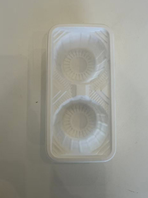 White plastic coffee cup container/holderwith two circular compartments on a light gray background